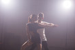 © satura_ - Young couple dancing latin dance Bachata, merengue, salsa. Two elegance pose in dance class