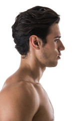 Wall Mural - Profile shot of handsome shirtless athletic young man in jeans, looking at camera in studio shot, isolated on white background