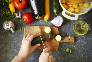 Fresh vegetables and cooking pan on table, top view. Healthy food and eating concept. Preparing for vegetable ragout.