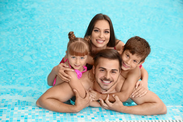 Poster - Happy family resting in swimming pool with refreshing water