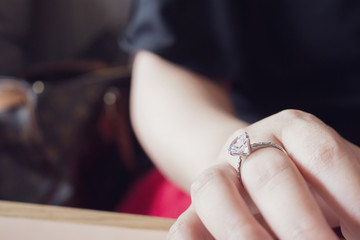 engagement diamond ring on woman finger closeup