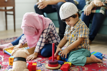 Poster - Muslim family relaxing and playing at home