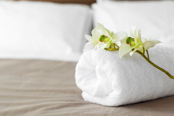 Sticker - towels and flower on bed in hotel room