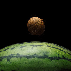 Wall Mural - view of earth from the moon surface. watermelon and coconut background. abstract space fruit concept