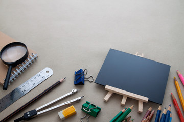 High angle view of stationary with blank black board on workspace desk, Back to school