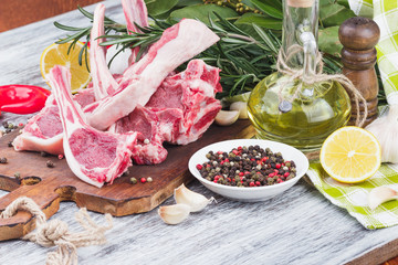 Raw meat and food ingredients on the wooden board