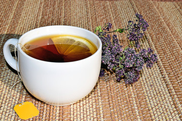 A Cup of green tea with lemon. Tea with medicinal herbs. Tea with thyme and lemon. Tea to boost immunity.