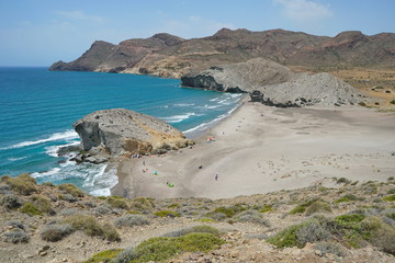 Wall Mural - Sandy beach and rock formation on the sea shore, Playa de Mónsul in the Cabo de Gata-Níjar natural park, Mediterranean sea, Almeria, Andalusia, Spain