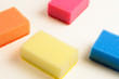 © OlekStock - Scattered four red blue orange and yellow sponges for dishwashing on white background. Cleaning concept