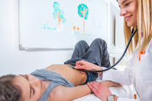 Pediatrician Examining Boy’s Abdomen