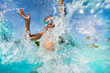 canvas print picture - Happy boy playing and splashing in swimming pool