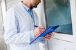 © LIGHTFIELD STUDIOS - cropped image of veterinarian with clipboard checking rooms at veterinary clinic