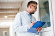 © LIGHTFIELD STUDIOS - side view of veterinarian with clipboard checking rooms at veterinary clinic