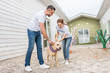 © LIGHTFIELD STUDIOS - adult volunteers of animals shelter playing with labrador dog