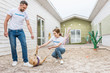 © LIGHTFIELD STUDIOS - happy volunteers of animals shelter playing with labrador dog