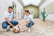 © LIGHTFIELD STUDIOS - two volunteers of animals shelter playing with labrador dog