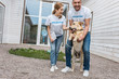 © LIGHTFIELD STUDIOS - two volunteers of animals shelter having fun with labrador
