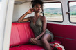 © ADDICTIVE STOCK - Gorgeous black woman sitting on back seat of van