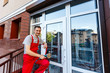 © Angelov - builders worker installing glass windows on facade of business building using glass suction plates