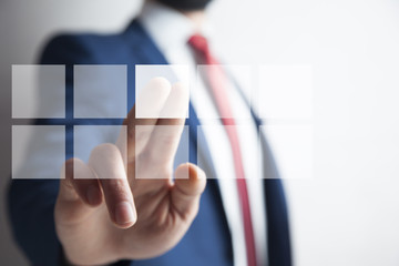 Businessman pressing virtual buttons in concept