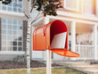 © ekostsov - Orange mail box with big house on background, 3d rendering