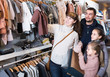 © JackF - family with daughters deciding on clothes for baby in children’s clothes shop