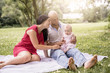 © Louis-Paul Photo - Happy family with Baby girl lay on a blanket