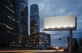 Fototapeta  - Blank billboard at twilight next to skyscrapers. 3d rendering