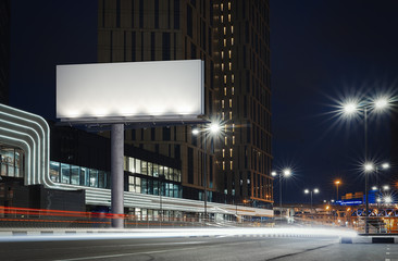 Wall Mural - Blank illuminated billboard near well-lit road at night time. 3d rendering