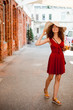 © FollowTheFlow - Summer sunny lifestyle portrait of young beautiful woman walking on the street market, wearing cute red trendy dress, drinking tasty smoothie, smiling enjoy her weekends, holiday.