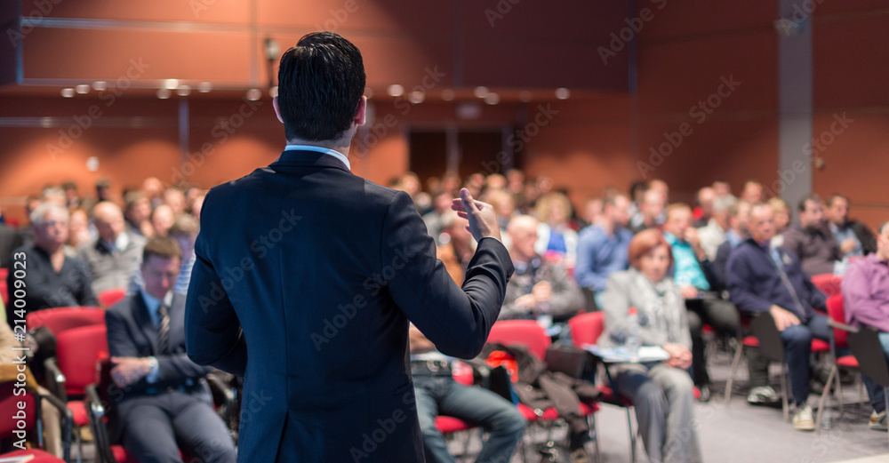 Speaker giving a talk on corporate business conference. Unrecognizable people in audience at conference hall. Business and Entrepreneurship event. - obrazy, fototapety, plakaty 