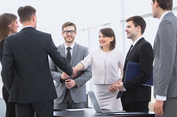 handshake of business partners standing next to their lawyers