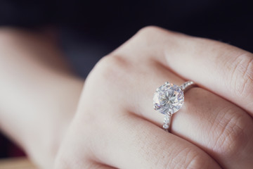 engagement diamond ring on woman finger closeup