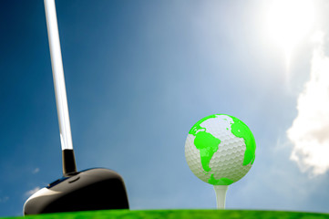 globe on golf ball on green grass