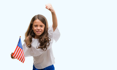 Brunette hispanic girl holding flag of United States of America annoyed and frustrated shouting with anger, crazy and yelling with raised hand, anger concept