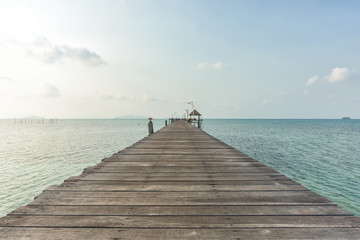 Wall Mural - Long wooden bridge go to pavilion on the sea in beautiful tropical island, Thailand.