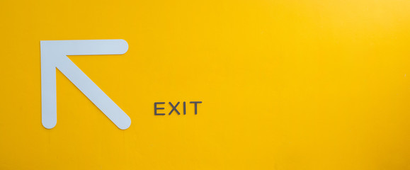 yellow exit sign, empty space.