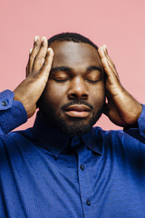 Wall Mural - Portrait of a man in with hands on headt, isolated on pink background