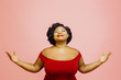 © Carlos David - Life is wonderful/ Portrait of a confident, satisfied and happy woman with both hands out, isolated on pink