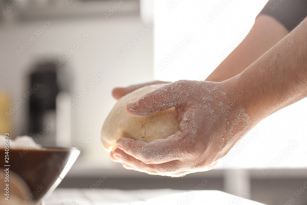 Baker holding dough, closeup