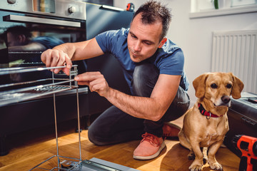 Wall Mural - Man with dog building kitchen cabinets