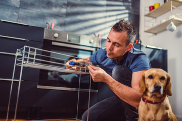 Wall Mural - Man with dog building kitchen cabinets