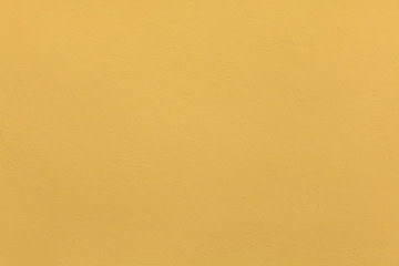 Wall Mural - Yellow ochre painted stucco wall. Background texture