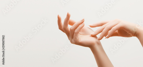 Cuadros en Lienzo Closeup image of beautiful woman's hands with light pink manicure on the nails