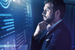 © Viacheslav Yakobchuk - Attentive look. Calm clever programmer wearing an elegant suit and frowning while thoughtfully touching his beard and looking at the information on the transparent screen