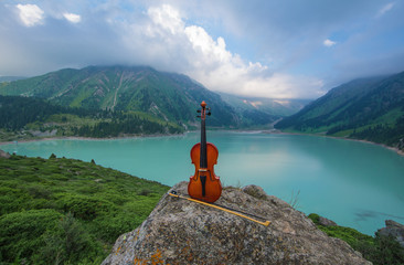 violin on the background of Mountain Lake