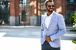 © halayalex - Portrait of sexy handsome fashion businessman model dressed in elegant blue suit posing on street background. Metrosexual