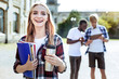 © Viacheslav Yakobchuk - My group mates. Cheerful girl keeping smile on her face and holding thermo cup in left hand while posing on camera
