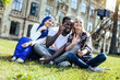 © Viacheslav Yakobchuk - Peaceful mind. Excited young people smiling broadly while sitting outdoors and gesturing with a peace sigh for a selfie.