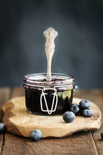 Homemade Blueberry Preserves In A Canning Glass Bail Jar With Antique Spoon. Extreme Shallow Depth Of Field With Selective Focus On Jam.